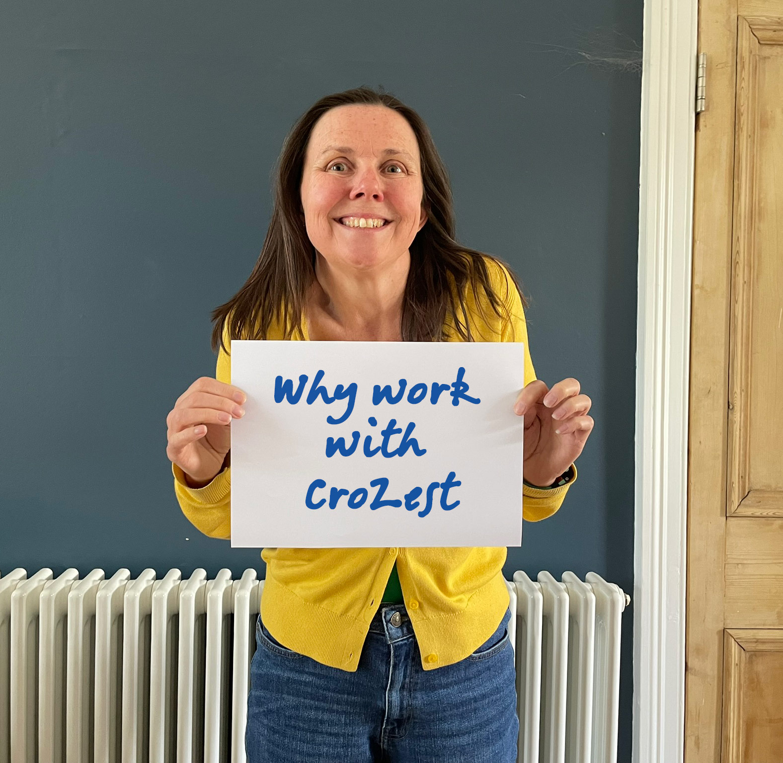 Sandra Phillipson holding sign 'Why work with CroZest?'